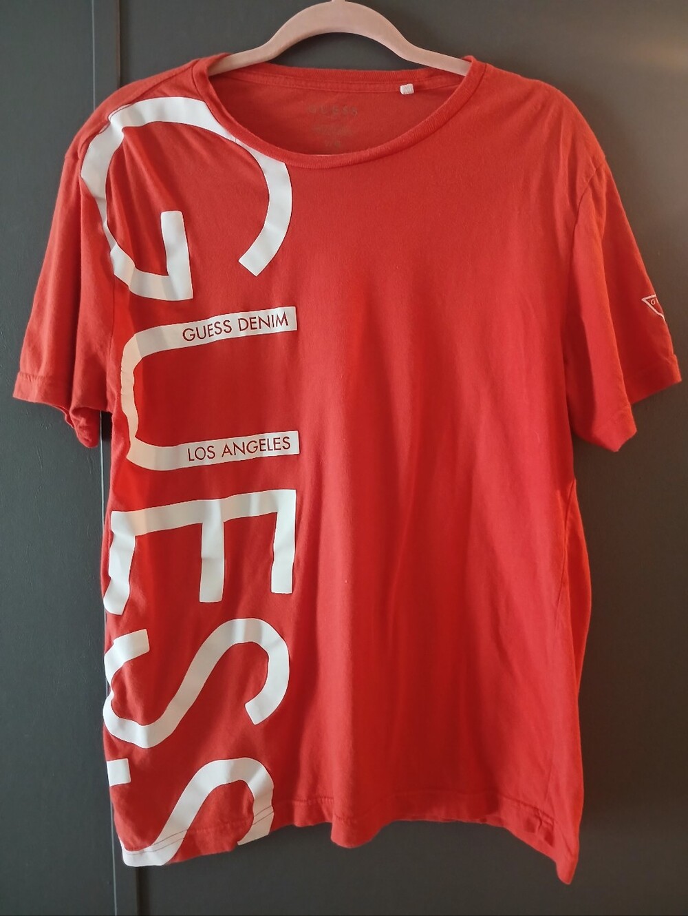 GUESS t-shirt men's coral color, vertical white logo print down the left side L